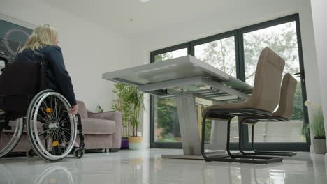 woman in wheelchair entering home office