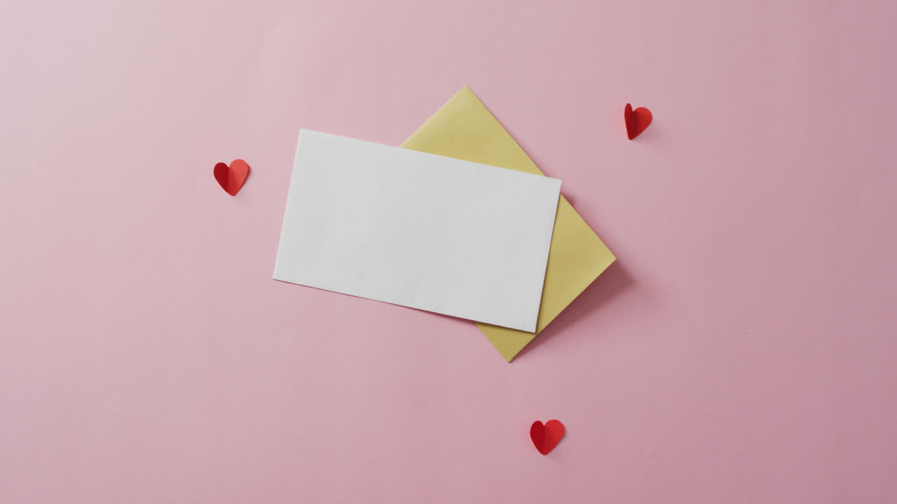 Envelopes and red hearts on pink background at valentine's day