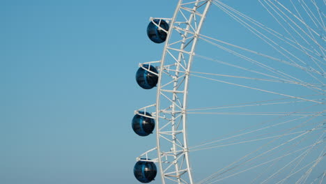 sokcho eye - ferris wheel against blue sky at sunset in sokcho city, south korea - zoom out from one cabin to whole structure