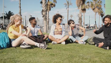 chilling young friends on summer lawn