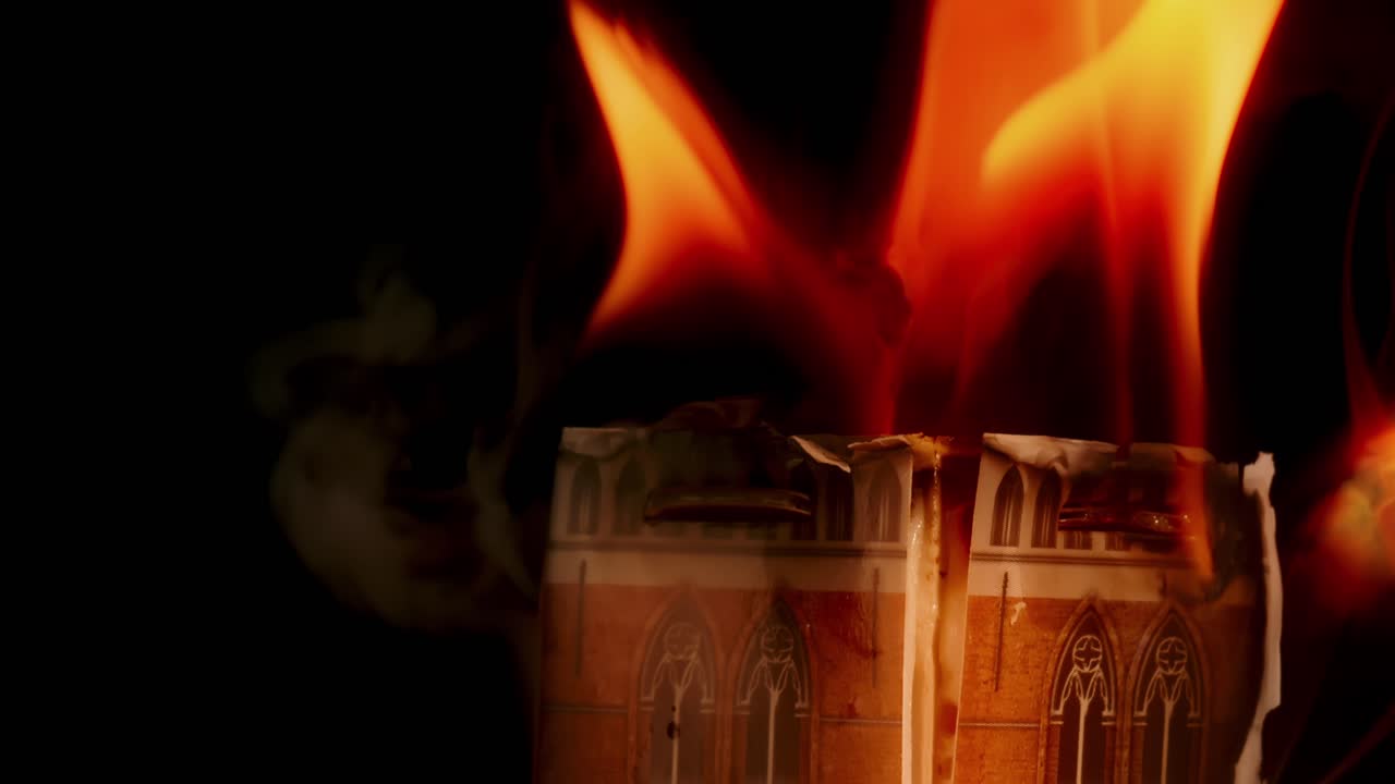 Closeup of Belfry of Bruges bell tower 13th century Gothic building struck by fire, miniature act against black background, Studio shot, Bruges
