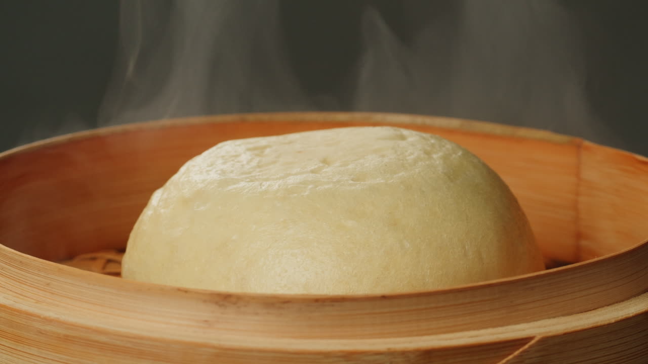 Close-up of Steaming Hot Bun in Bamboo Steamer