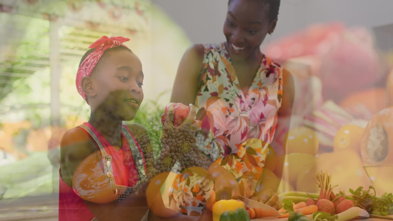 video compuesto de verduras contra madre e hija afroamericanas recogiendo verduras