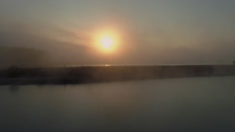 Misty sunrise at scenic Frydman lake in Poland creating dreamy feeling