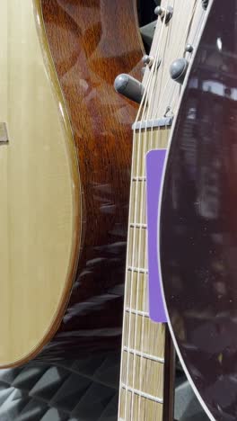Closeup of a man enthusiastically playing chords on an acoustic guitar.