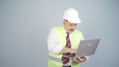 engineer working on project on laptop.