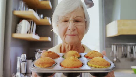 grandma holding muffin trey and smelling fresh muffins 4k 4k