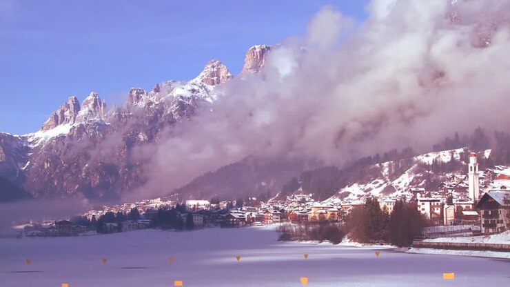 Time lapse of a distant snowbound village in the Alps in Austria Switzerland Italy Slovenia or an Eastern European country