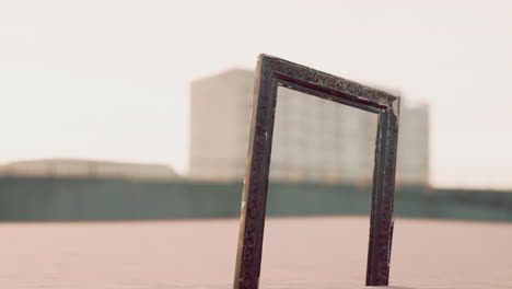 empty wooden picture frame on the beach sand