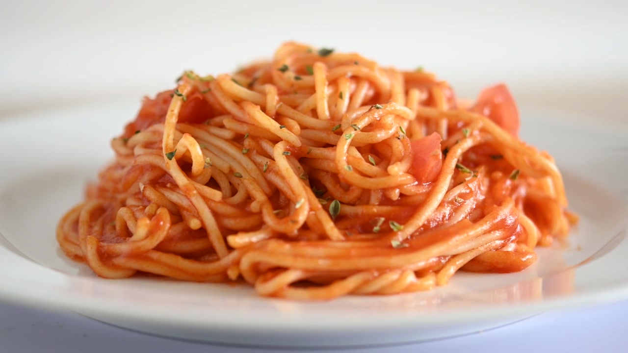 皿の上で回転するトマトソースのスパゲッティ