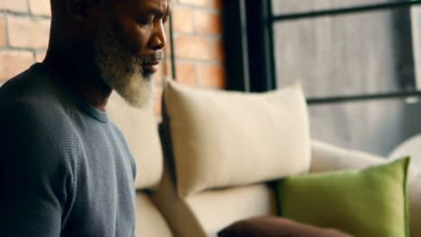 senior man writing on a diary in living room 4k