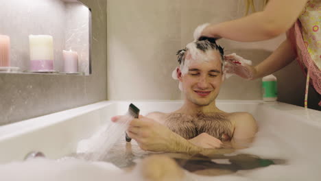 man and woman enjoying a bubble bath