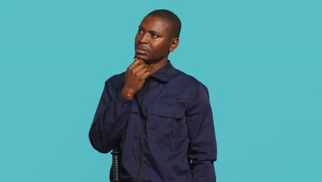 portrait of pensive bodyguard rubbing chin, doing thinking hand gesture