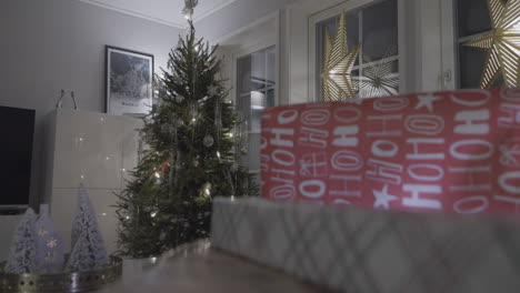 close-up of gifts with christmas tree on the back