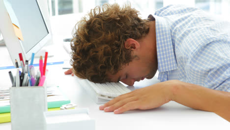 Exhausted-businessman-sleeping-with-his-head-on-the-keyboard-