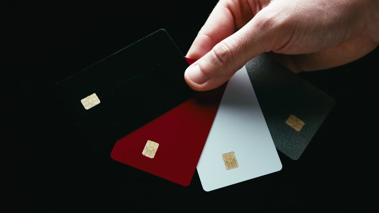 Colorful payment cards held in hand by a person during Black Friday shopping