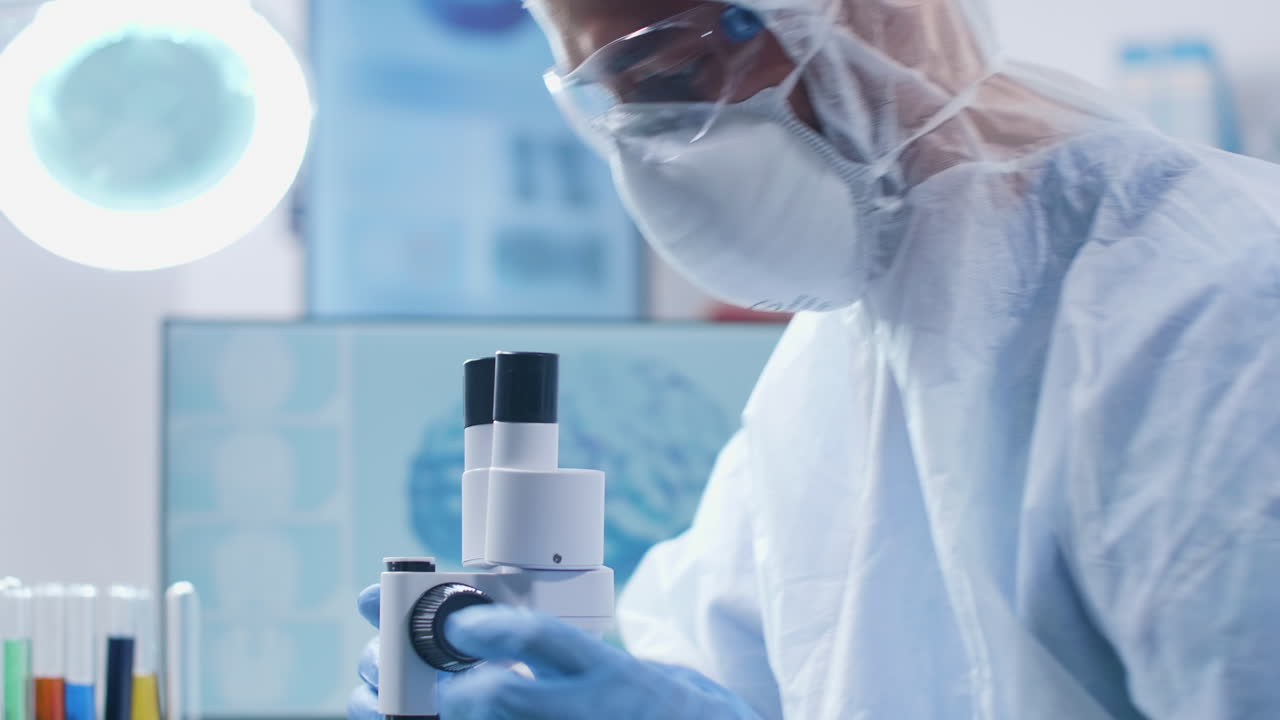 Scientist conducting research in a laboratory using a microscope