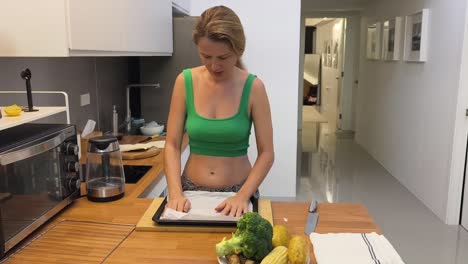 woman preparing vegetables and food in a kitchen