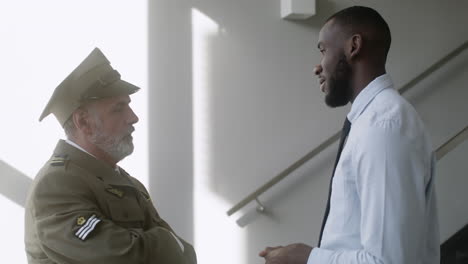 two men talking on the hallway