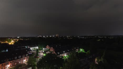 time lapse sequence of thunderstorm lightning at night over a village