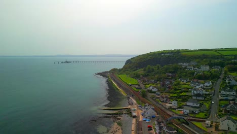 Aerial-shot-of-Whitehead,-a-seaside-village-in-Co