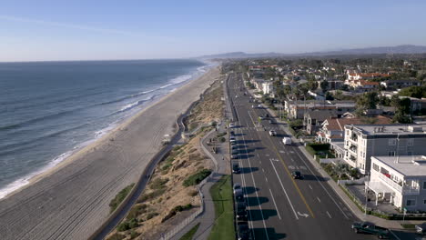 aerial view of a coastal road and beachfront residential area