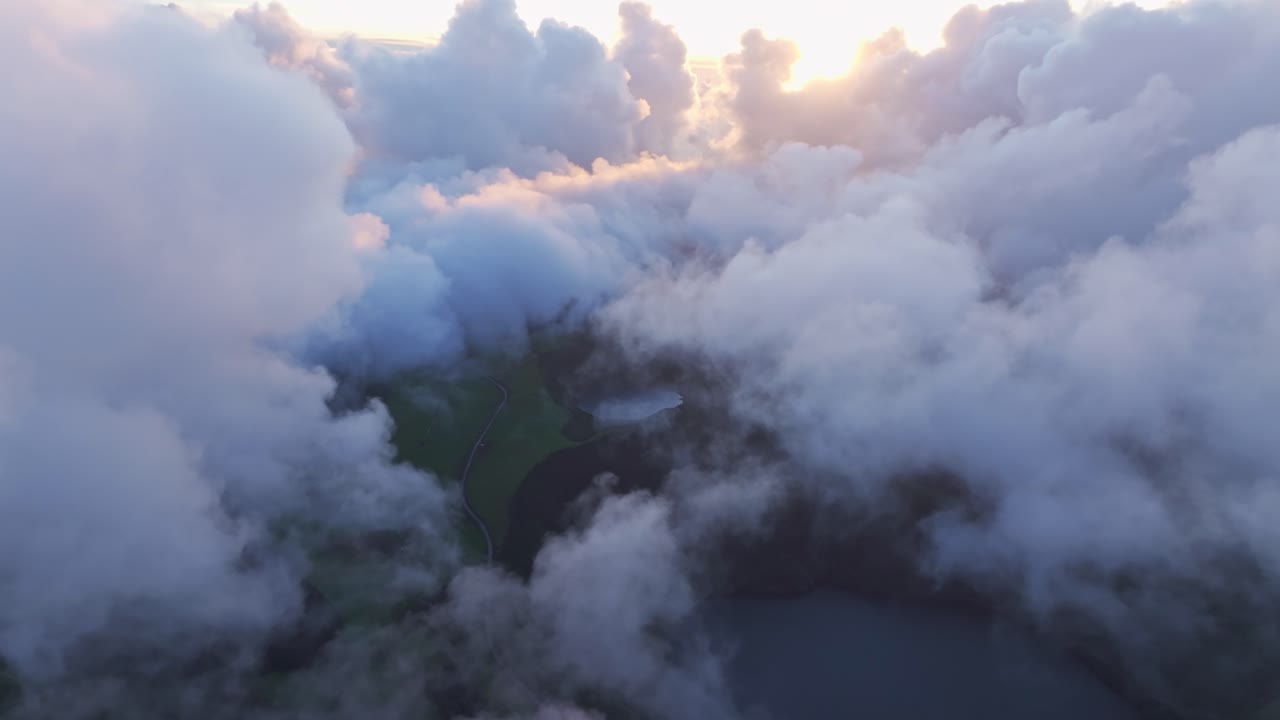 Aerial view of majestic green lagoon overlook in Sete Cidades, Azores, showing under layered clouds