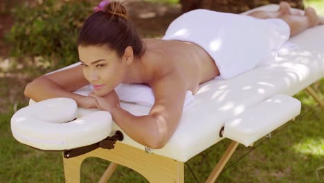 dreamy young woman enjoying a spa treatment
