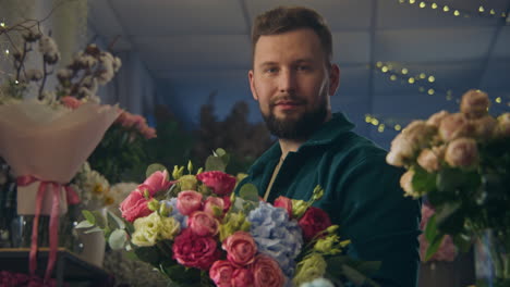 florist collects bouquet and looks at camera