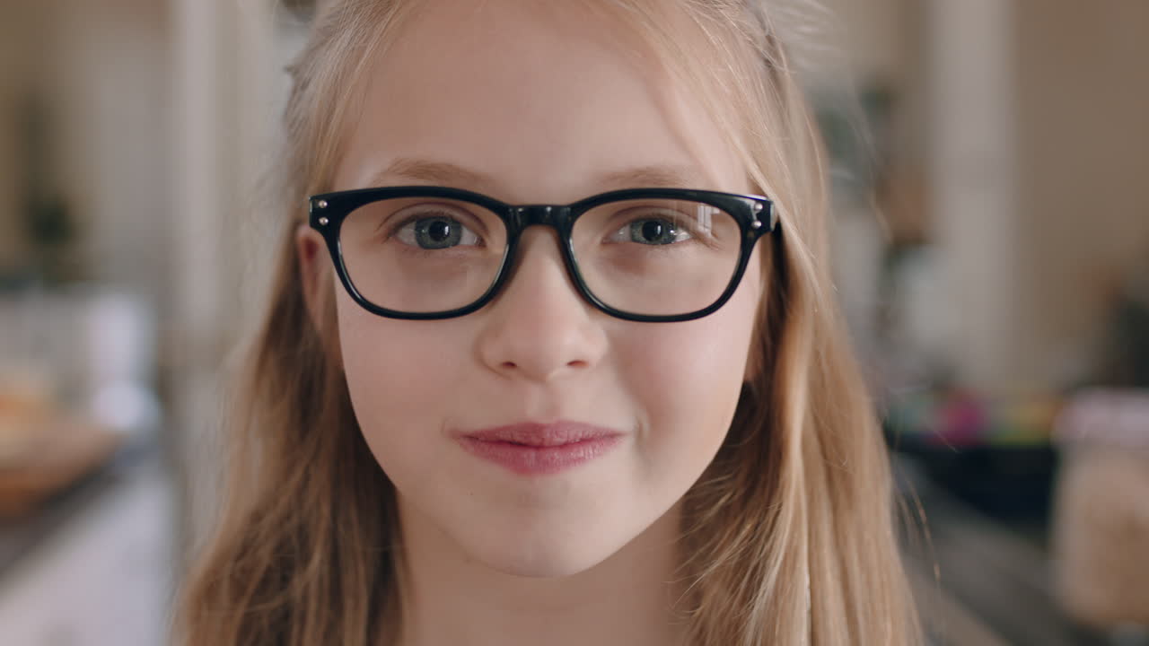 portret pięknej szczęśliwej dziewczyny uśmiechającej się w okularach patrzącej na kamerę przyjazne dziecko cieszące się szczęściem dzieciństwa