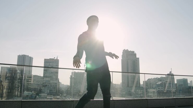Contemporary hip hop street dancer hipster man with tattoo funky urban dancing freestyle in the city