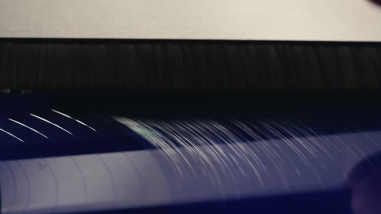 Close Up of a Vinyl Record Being Cleaned by a Brush