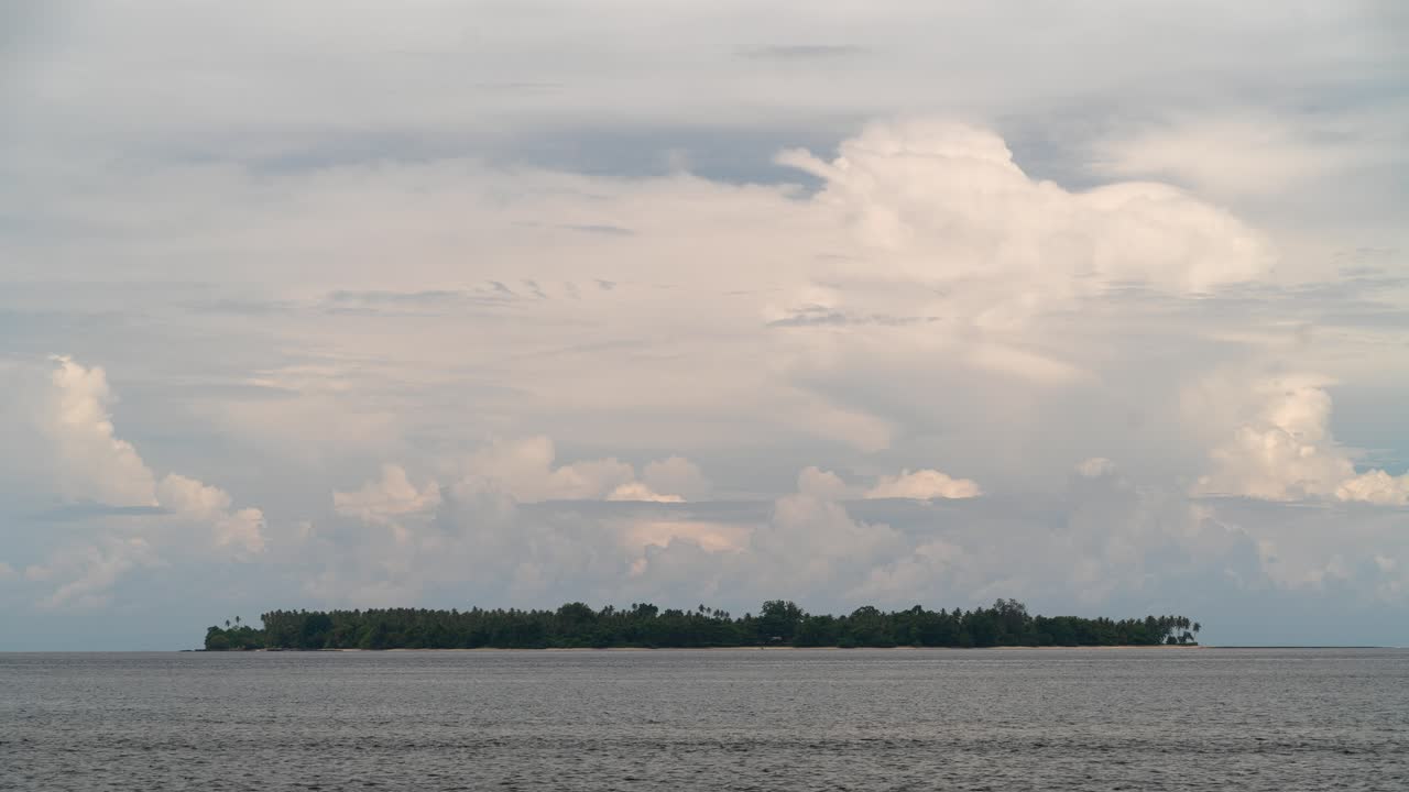 Remote Tropical Island Under a Cloudy Sky