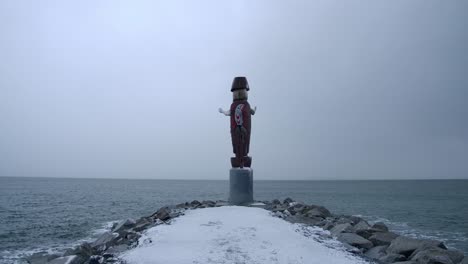 wooden native statue, west vancouver ambleside beach, snowy winter day