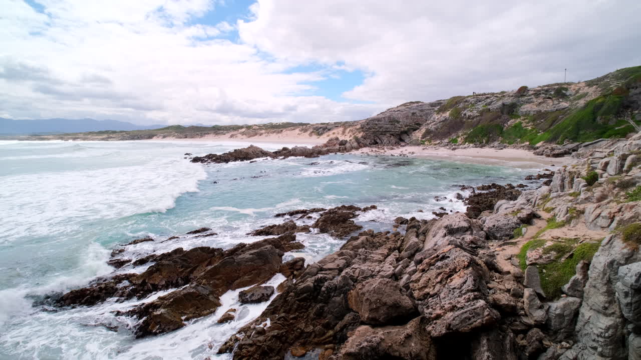 High angle view over Walker Bay nature reserve coastline as waves roll in