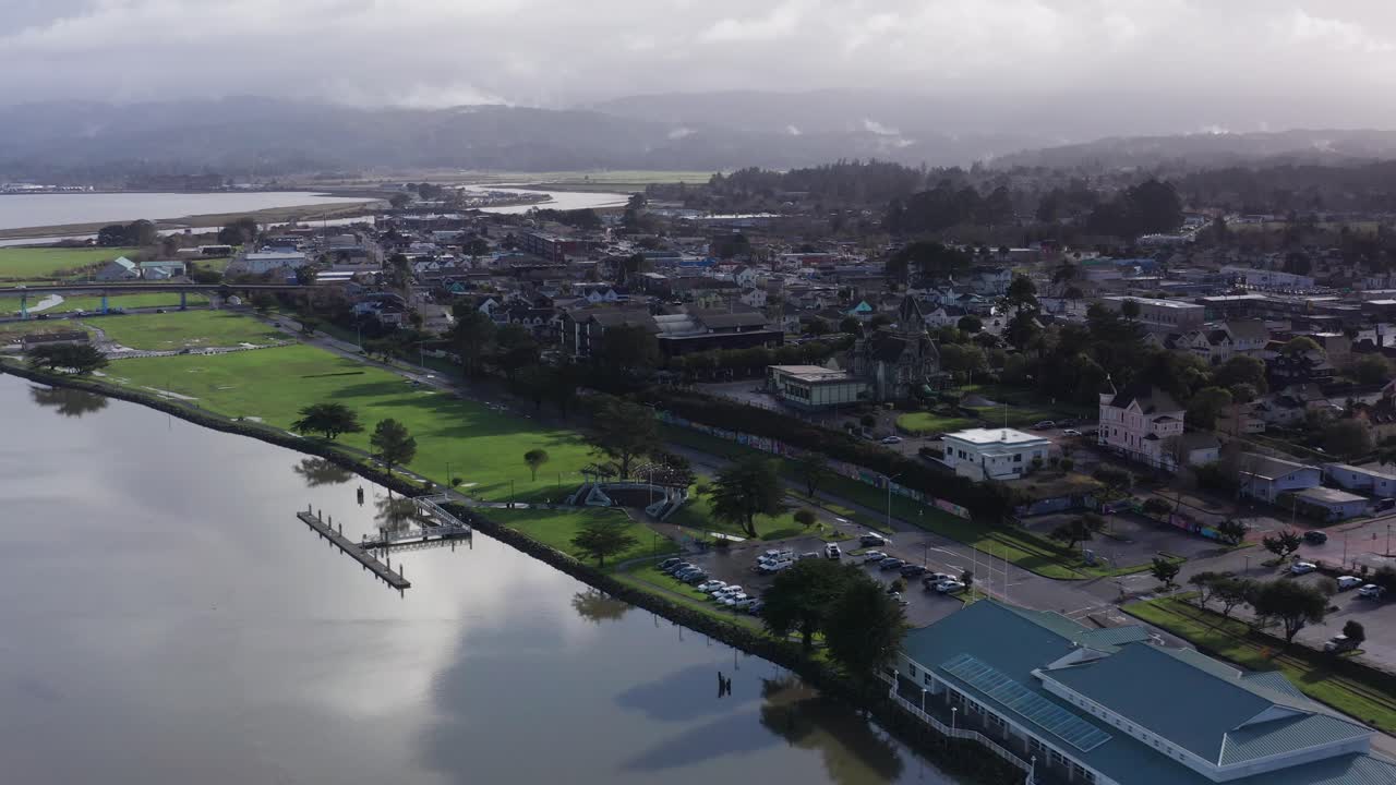 Aerial wide shot flying over waterfront Halvorsen Park in Eureka, California. 4K