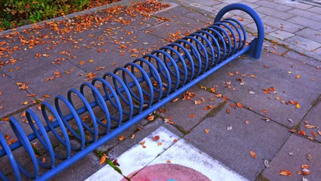 blue bicycle parking stand near painted crossed circle sign