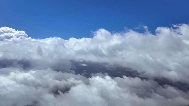 Exclusive POV shot flying between layers of ethereal fluffy stratus type clouds. Aerial footage taken from a jet airplane cockpit. Ultra-realistic 4K shot