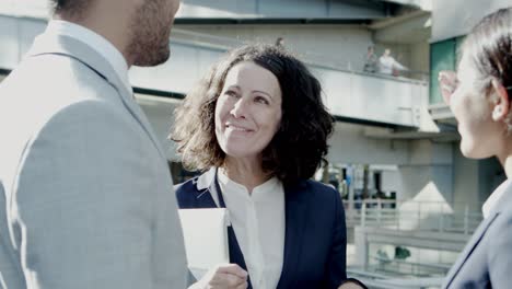 emotional business people talking on street