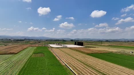 crude oil storage tanks in the middle of farming lands in the countryside