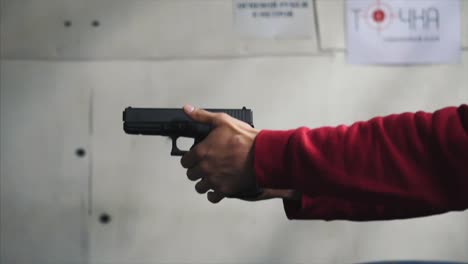 person holding a handgun at a shooting range