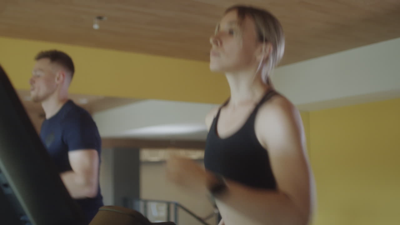 Woman Jogging on Gym Treadmill