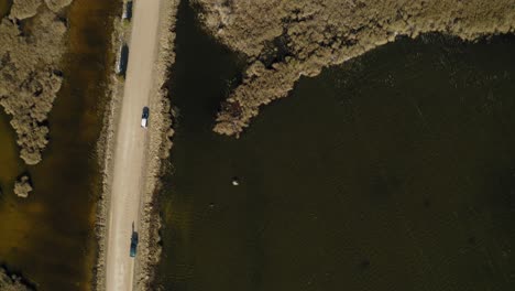 Descending-on-island-near-two-lake-divided-by-road-in-Latvia