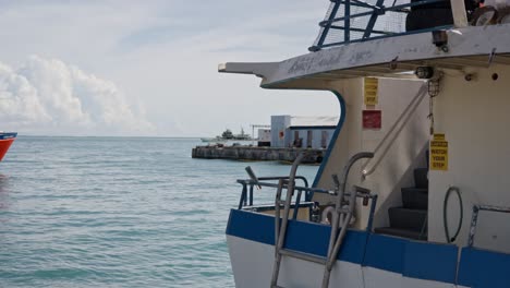 boat parked at port of saipan during a clear day