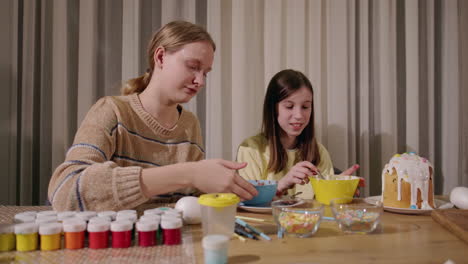 sisters decorating easter eggs and treats