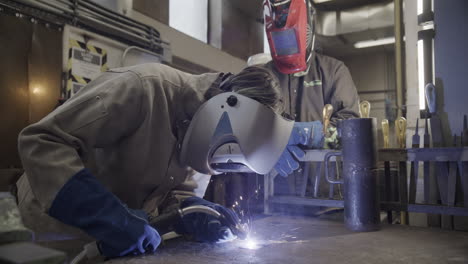 welders working together in a metal shop