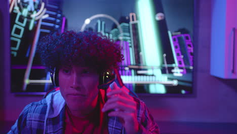 biracial man chats on headset amid neon lights, copy space