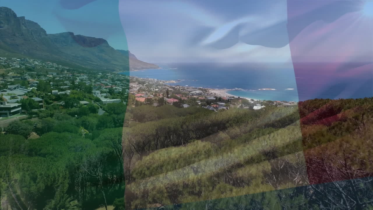 South African flag animation over scenic coastal landscape with mountains and ocean