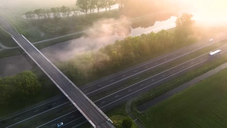 sunrise highway and bridge through foggy landscape