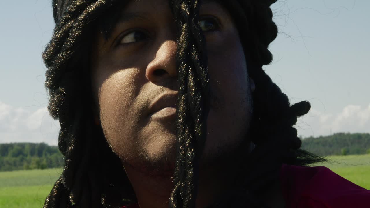 Samson looking up and around at surrounding green landscape, Biblical character with long dreads, Israelite warrior and judge, black male in old testament, Christian